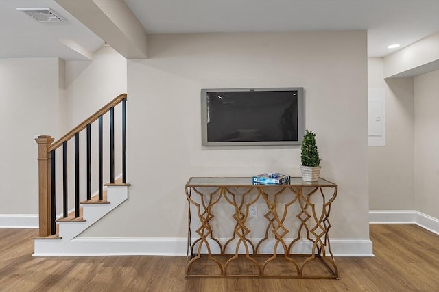 stairs featuring hardwood / wood-style floors