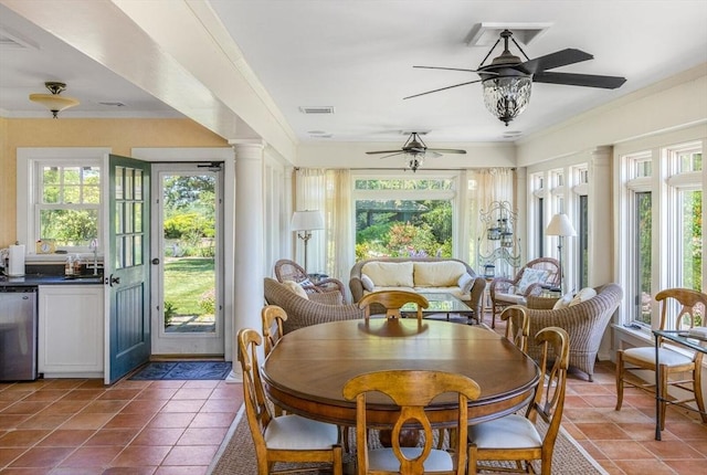 sunroom featuring a sink, ornamental molding, visible vents, and tile patterned floors