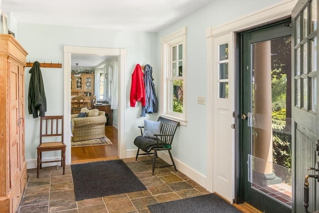 entryway featuring baseboards and stone finish flooring