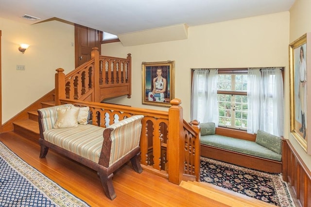 sitting room with visible vents and wood finished floors