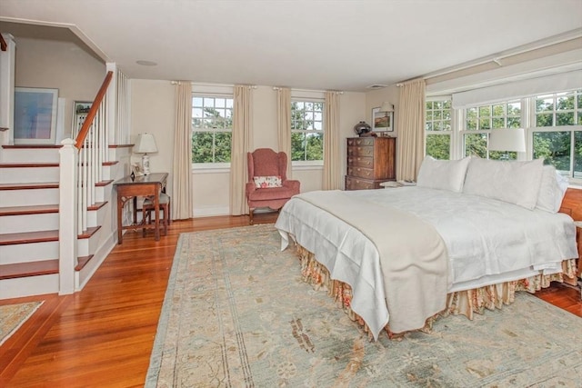 bedroom with baseboards and wood finished floors
