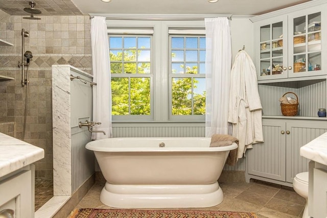 bathroom with a tile shower, toilet, tile patterned floors, recessed lighting, and a freestanding tub