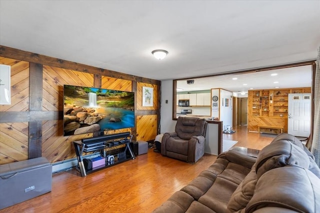 living room with wood walls, recessed lighting, and wood finished floors