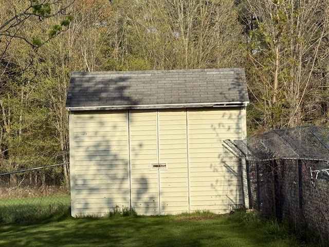 view of shed with fence