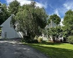 view of property exterior with a lawn