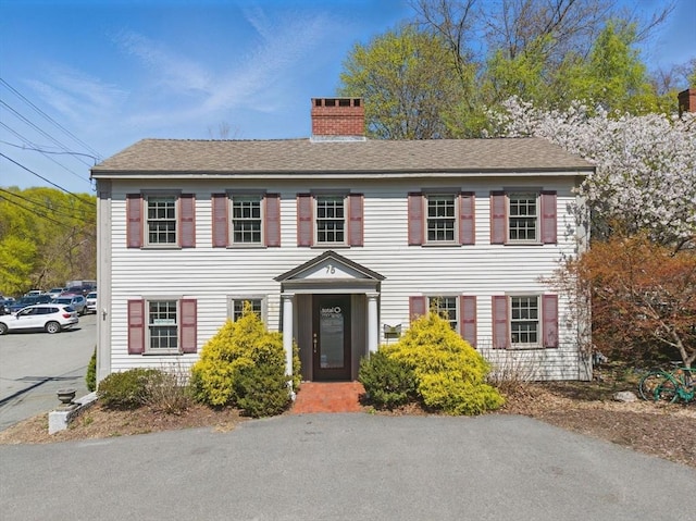 colonial home featuring a chimney