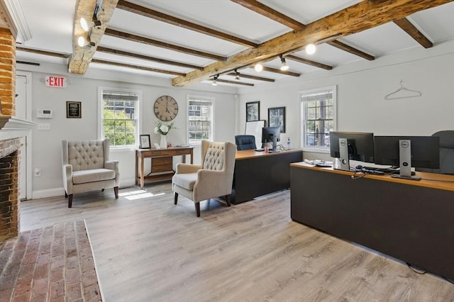 home office with a healthy amount of sunlight, baseboards, a brick fireplace, and light wood-type flooring