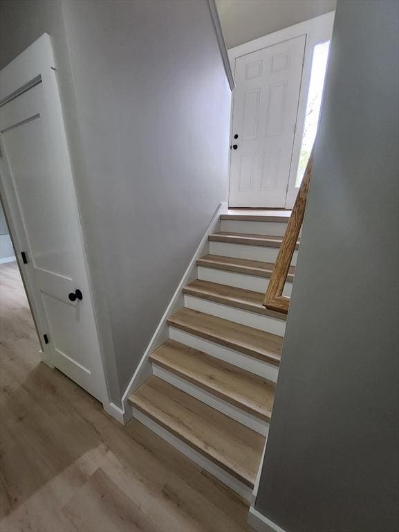 staircase with wood finished floors