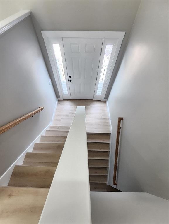 stairway with wood finished floors