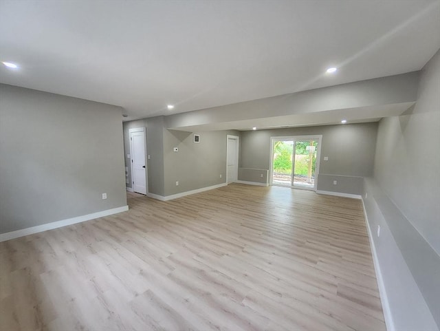 unfurnished room with light wood-type flooring, baseboards, and recessed lighting
