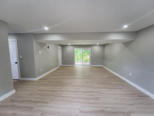 unfurnished room with light wood-style floors, baseboards, and recessed lighting