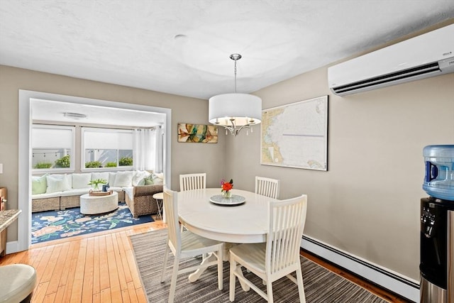 5 Cliff Estates Rd, Scituate, MA 02066 - dining room with a wall mounted AC, a baseboard heating unit, a chandelier, and wood-type flooring