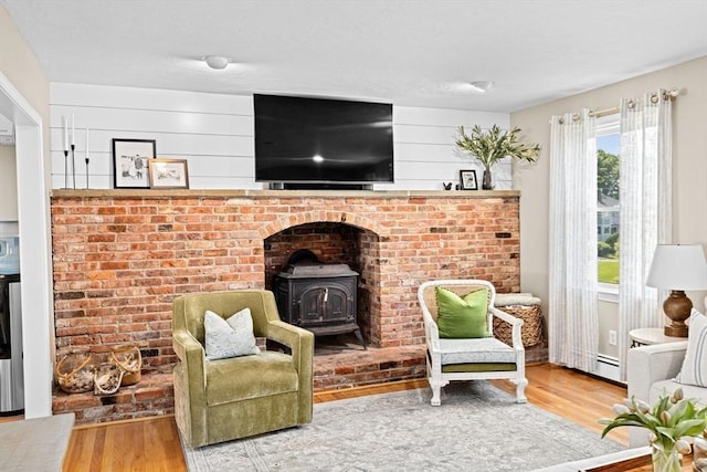 5 Cliff Estates Rd, Scituate, MA 02066 - living room featuring a wood stove, wood finished floors, and baseboard heating
