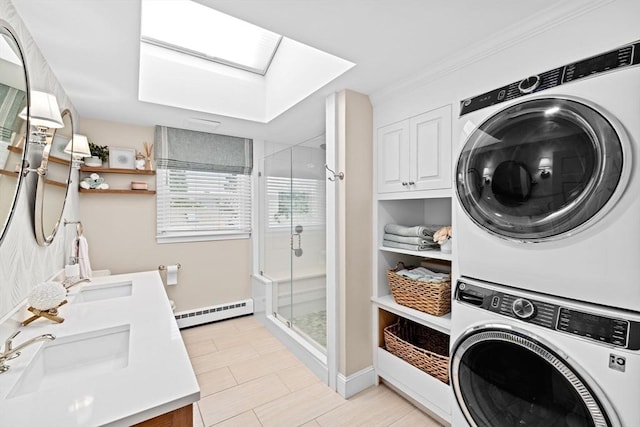 5 Cliff Estates Rd, Scituate, MA 02066 - laundry room featuring stacked washing machine and dryer, baseboard heating, and a skylight