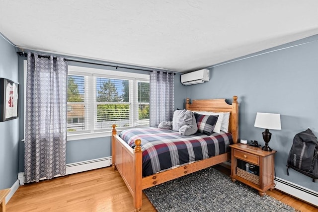 5 Cliff Estates Rd, Scituate, MA 02066 - bedroom with an AC wall unit, a baseboard radiator, and wood finished floors