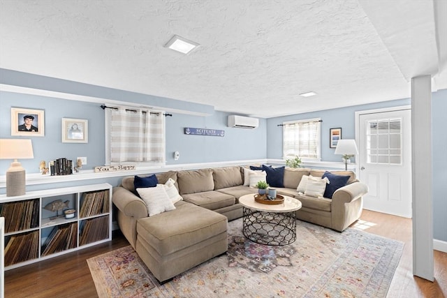 5 Cliff Estates Rd, Scituate, MA 02066 - living area with a wall mounted air conditioner, wood finished floors, and a textured ceiling