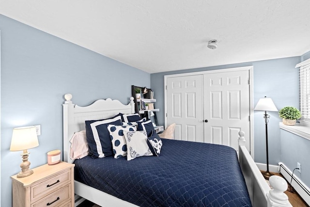 5 Cliff Estates Rd, Scituate, MA 02066 - bedroom with a baseboard heating unit, wood finished floors, and a closet