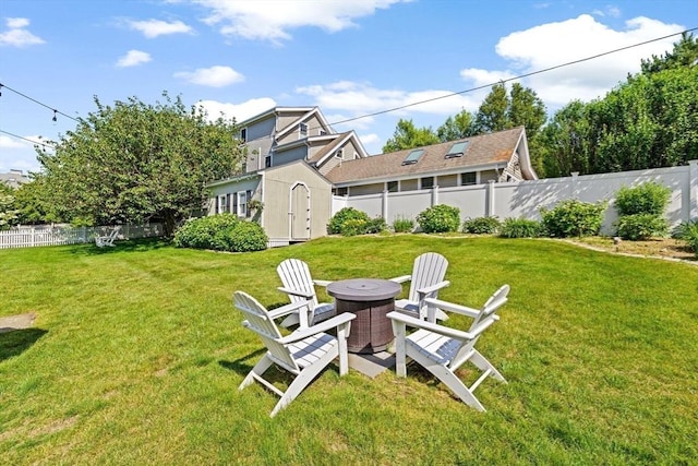 5 Cliff Estates Rd, Scituate, MA 02066 - fenced backyard with an outdoor fire pit and a storage unit