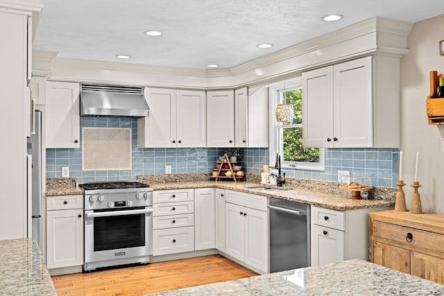 5 Cliff Estates Rd, Scituate, MA 02066 - kitchen featuring stainless steel appliances, extractor fan, light wood-style floors, light stone countertops, and crown molding
