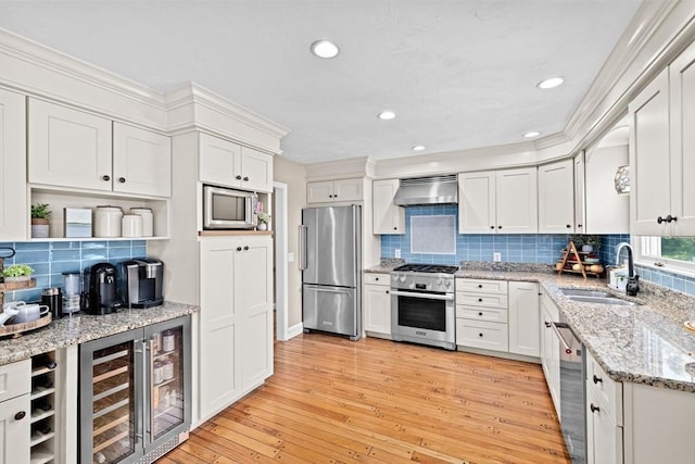 5 Cliff Estates Rd, Scituate, MA 02066 - kitchen featuring stainless steel appliances, exhaust hood, wine cooler, backsplash, and light wood-style flooring