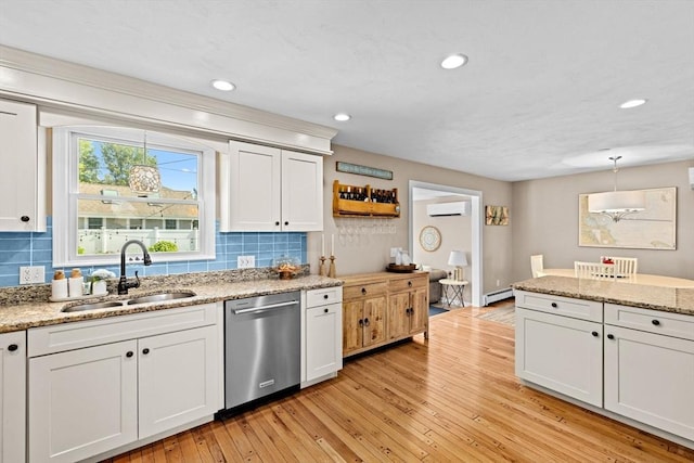 5 Cliff Estates Rd, Scituate, MA 02066 - kitchen with dishwasher, a wall mounted AC, tasteful backsplash, white cabinetry, and light wood-style floors