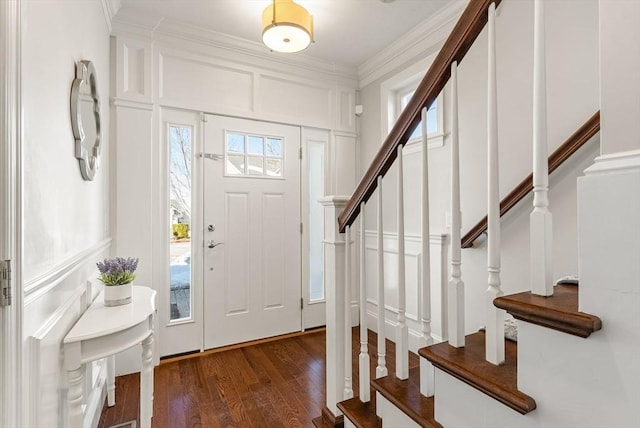 foyer entrance with crown molding and hardwood / wood-style flooring