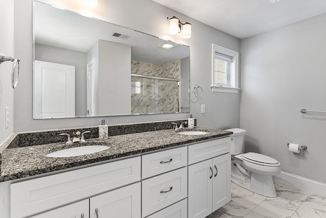 full bathroom with toilet, marble finish floor, a shower stall, and a sink