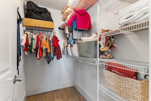 walk in closet featuring carpet flooring