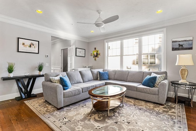 living room with dark wood-style floors, ornamental molding, and baseboards