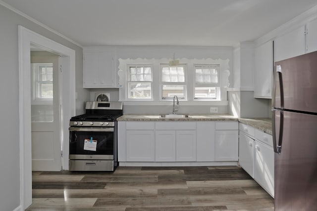 kitchen with appliances with stainless steel finishes, sink, dark hardwood / wood-style flooring, and white cabinets