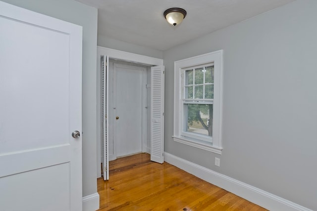 unfurnished bedroom with a closet and light hardwood / wood-style floors