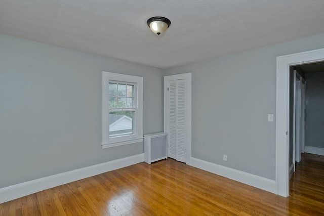 empty room with hardwood / wood-style floors