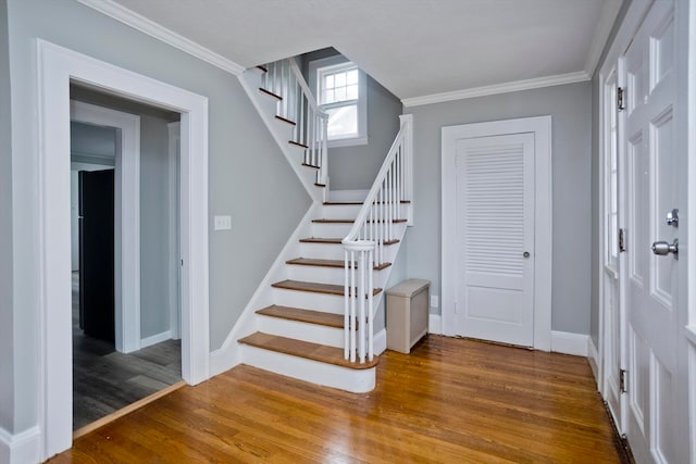 foyer featuring ornamental molding and wood-type flooring