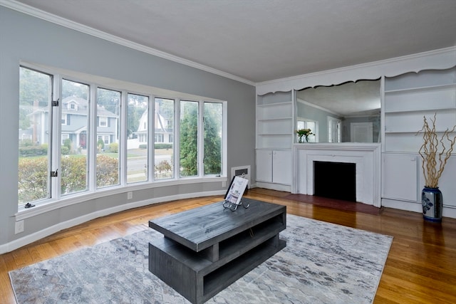 living room with wood-type flooring, a textured ceiling, a fireplace, and ornamental molding