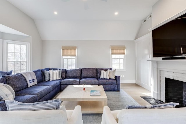 7 Colonial Dr, Chatham, MA 02633 - living room featuring lofted ceiling, wood finished floors, recessed lighting, a brick fireplace, and baseboards