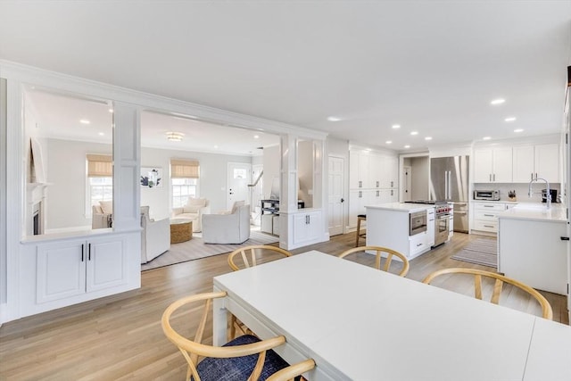 7 Colonial Dr, Chatham, MA 02633 - dining room featuring light wood-style flooring, recessed lighting, and ornamental molding