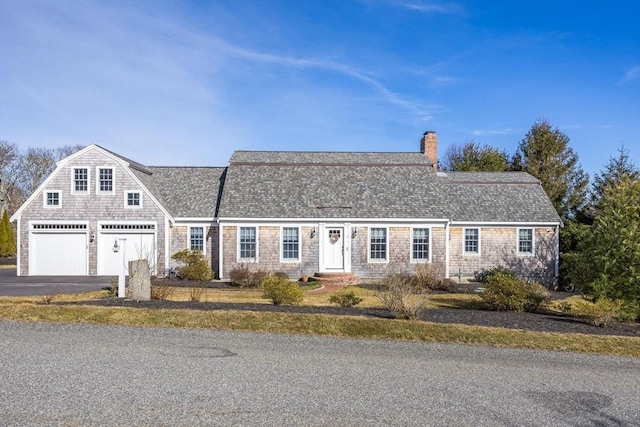 7 Colonial Dr, Chatham, MA 02633 - view of front of house featuring a chimney, asphalt driveway, roof with shingles, and an attached garage