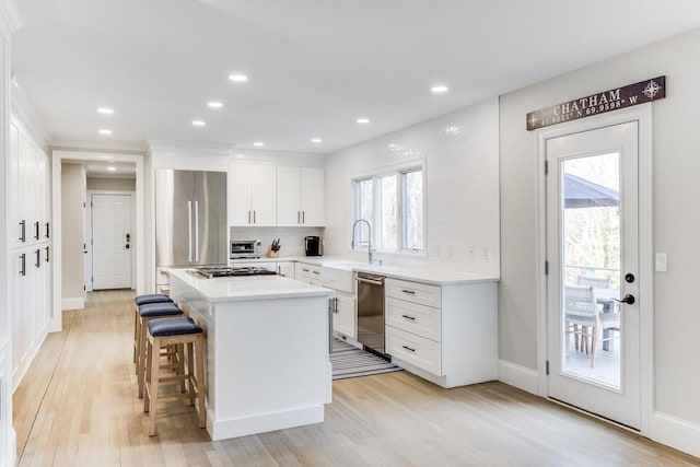 7 Colonial Dr, Chatham, MA 02633 - kitchen with stainless steel appliances, white cabinets, plenty of natural light, a center island, and recessed lighting