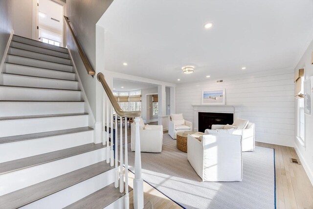 7 Colonial Dr, Chatham, MA 02633 - stairs with wood finished floors, a fireplace, recessed lighting, and wood walls
