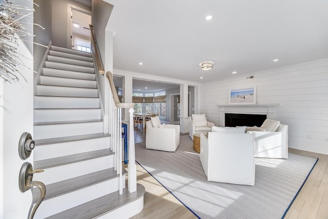 7 Colonial Dr, Chatham, MA 02633 - stairway with wood finished floors, a fireplace, recessed lighting, and wooden walls