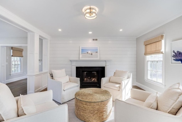 7 Colonial Dr, Chatham, MA 02633 - living area with crown molding, dark wood-style flooring, baseboards, a glass covered fireplace, and recessed lighting