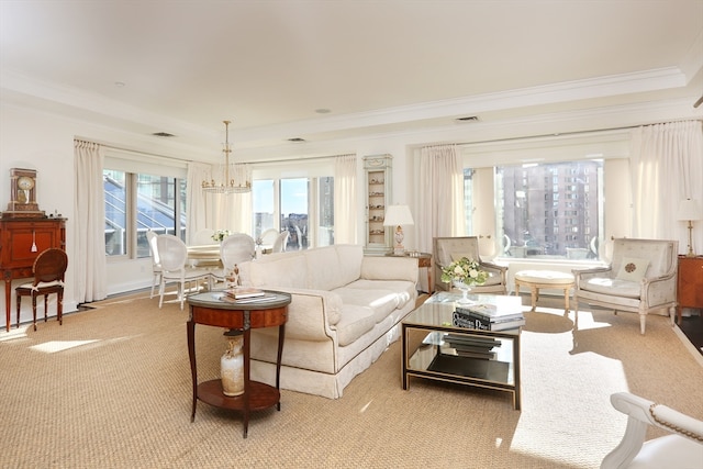 living room with a notable chandelier, crown molding, and light colored carpet