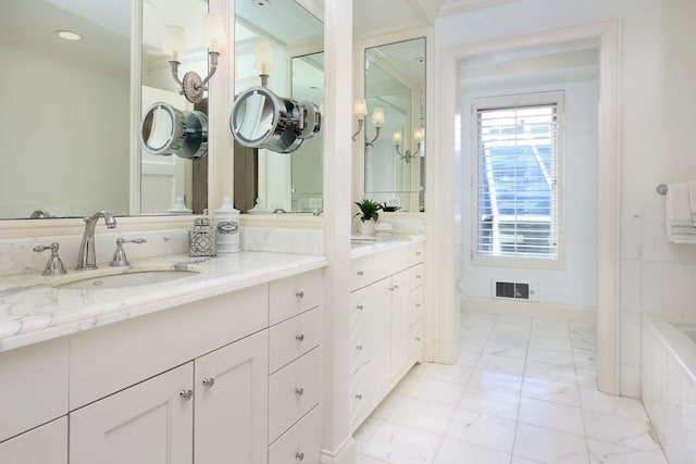 bathroom with a bathtub, tile floors, and vanity