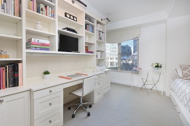 office space featuring crown molding and built in desk