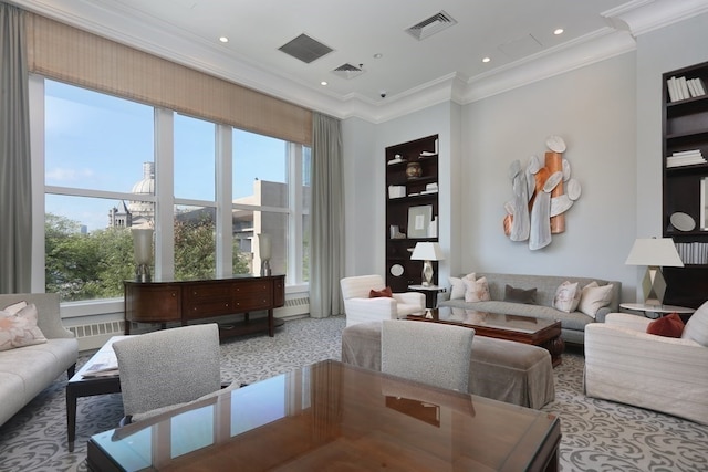 living room featuring ornamental molding, built in shelves, light colored carpet, and plenty of natural light