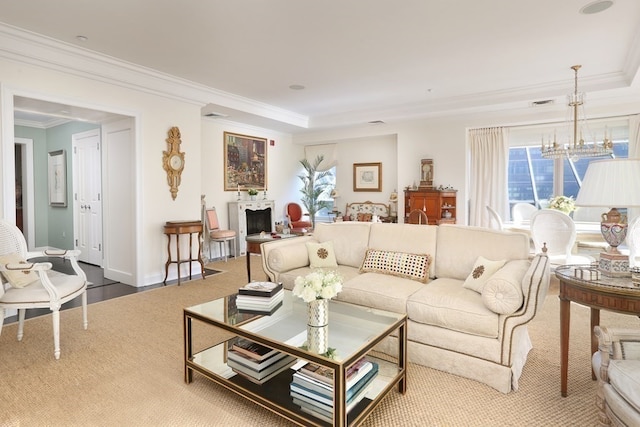 living room featuring ornamental molding, a chandelier, and a raised ceiling