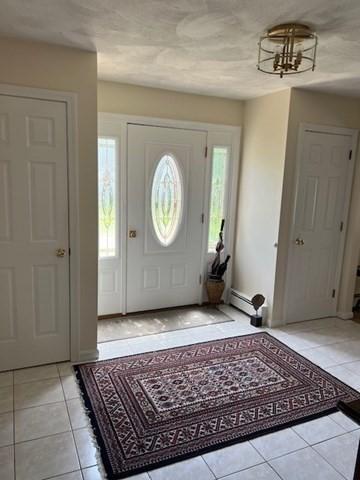 10 Atherton Rd, Hudson, MA 01749 - entryway featuring light tile patterned flooring and a baseboard radiator