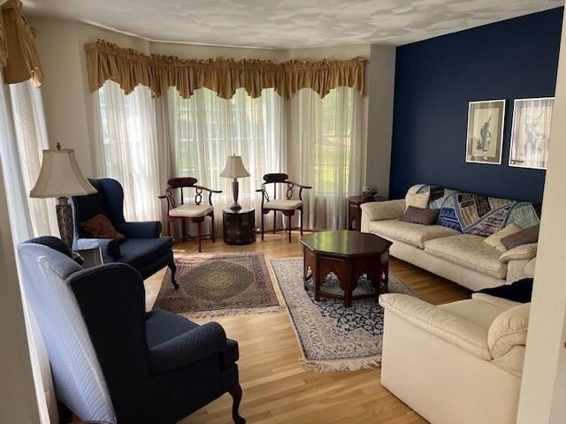 10 Atherton Rd, Hudson, MA 01749 - living area featuring healthy amount of natural light and wood finished floors