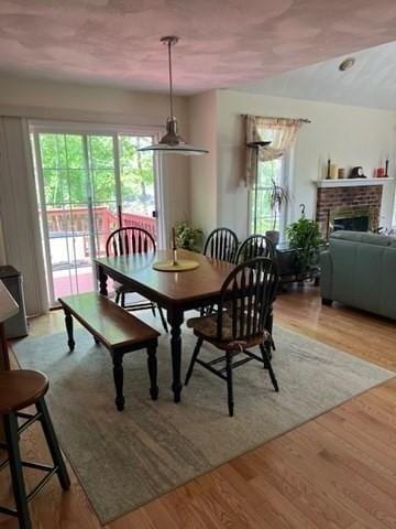 10 Atherton Rd, Hudson, MA 01749 - dining room featuring light wood-type flooring and a fireplace