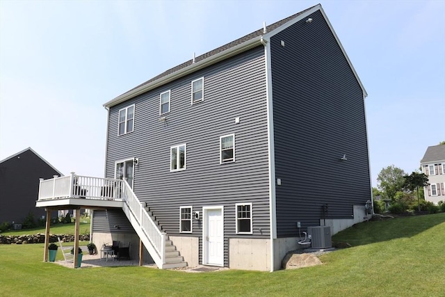 back of house featuring a yard, a patio, central air condition unit, and stairs